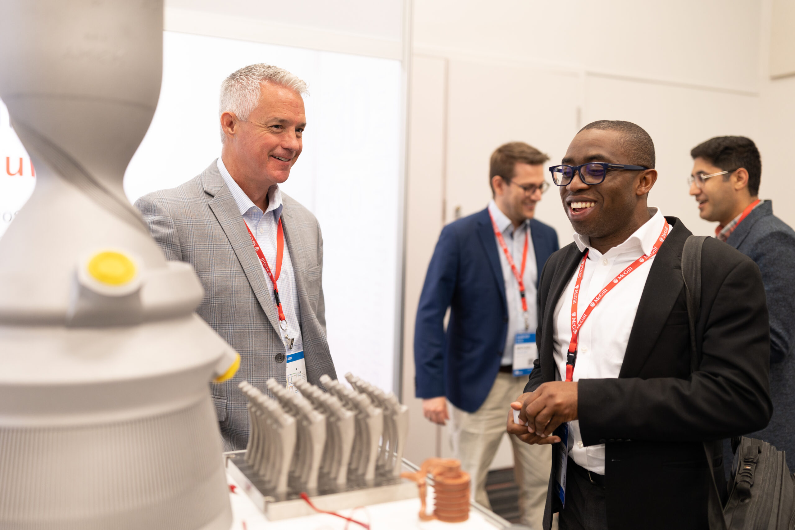 Attendee looking at metal 3D printed parts at HI-AM 2022.